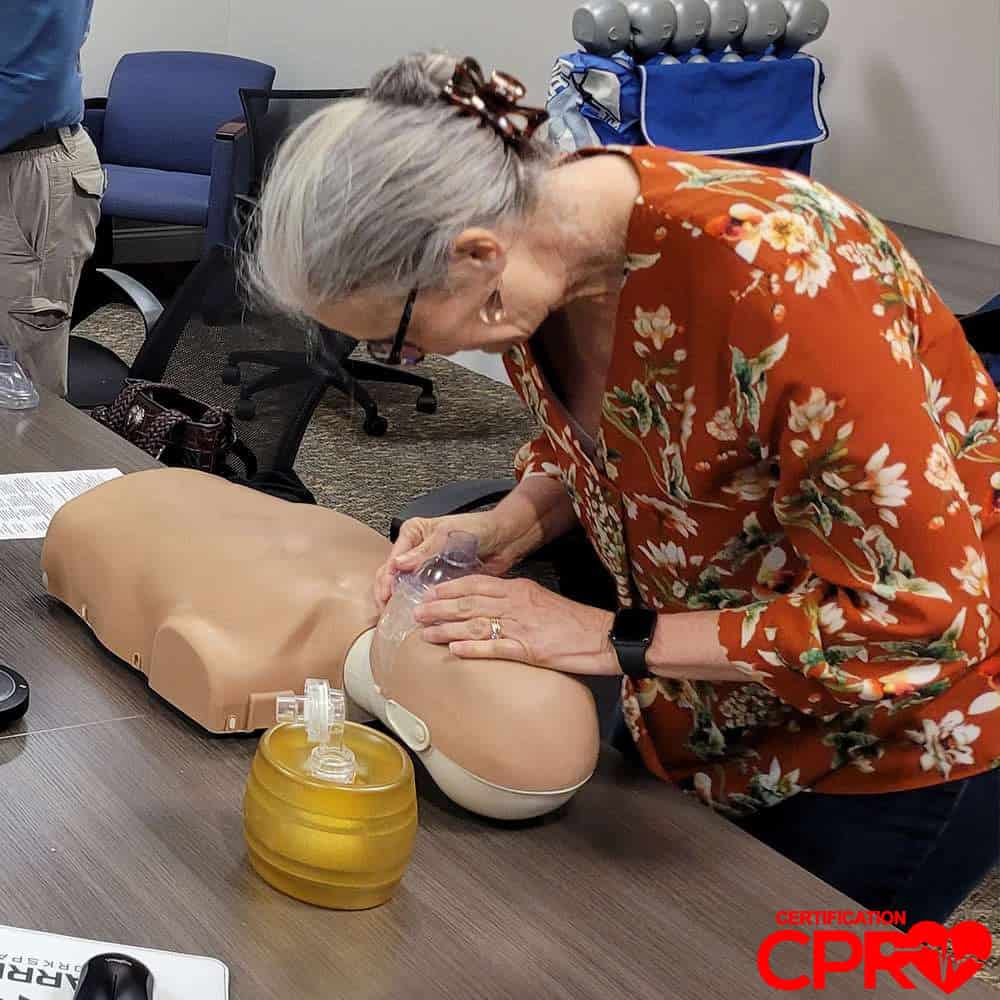 CPR training session with adult mannequin in Tallahassee.