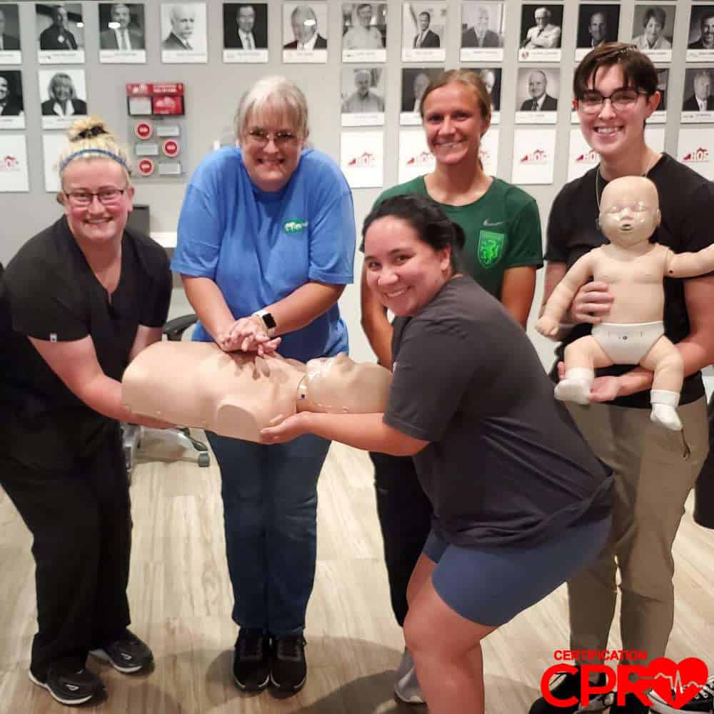 CPR training class in Tallahassee with students practicing on mannequins.