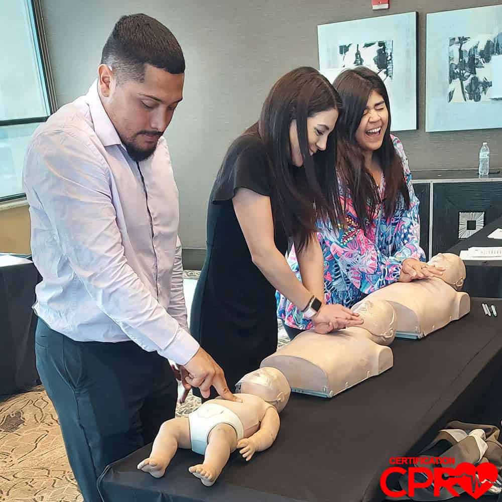 CPR training class in Tallahassee with students practicing on mannequins.