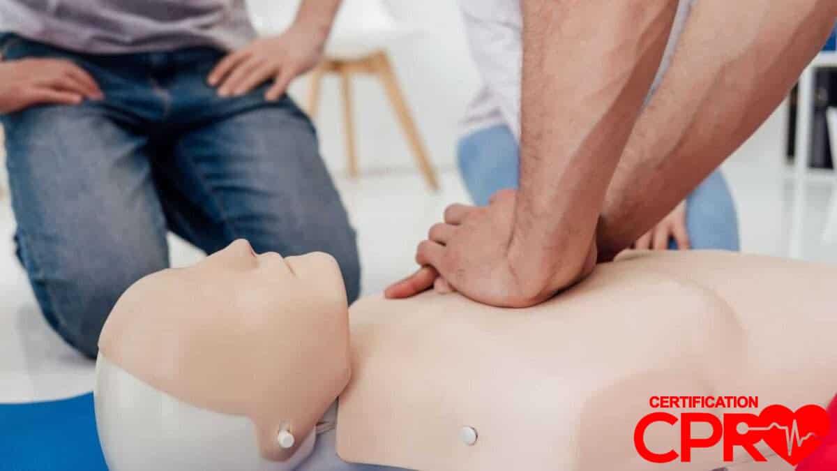 CPR training session with a man practicing on a mannequin in Tallahassee.